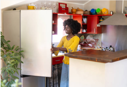 Woman opening fridge