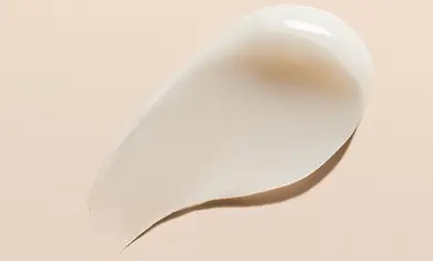 Swatch of Aveeno Eczema Therapy Cream showcasing its rich, moisturizing texture.