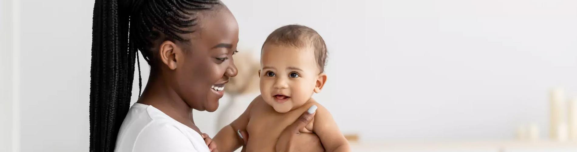 Mother Sitting on the Bed with Baby