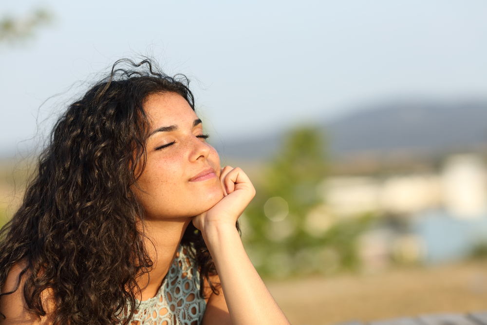 Woman relaxing enjoying the warmth of the sun