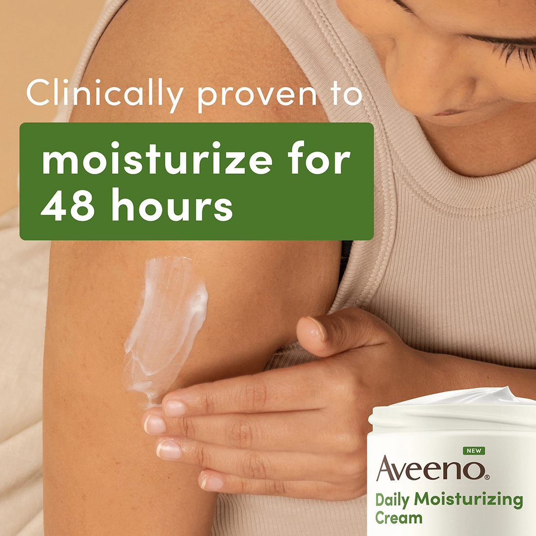 A woman wearing a beige tank top applies daily moisturizing cream to her arm. The cream is white and she is using her left hand to apply it. The background is a neutral beige color. The image says, "Clinically proven to moisturize for 48 hours."