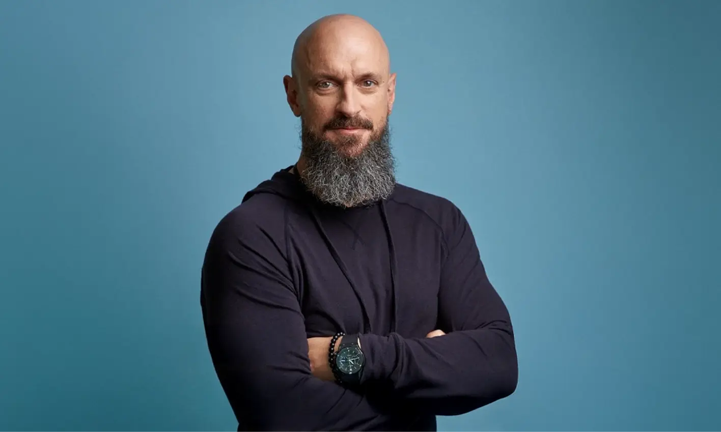 Man with arms crossed, banner featuring our perfurmer, Nose Kevin Scozzaro