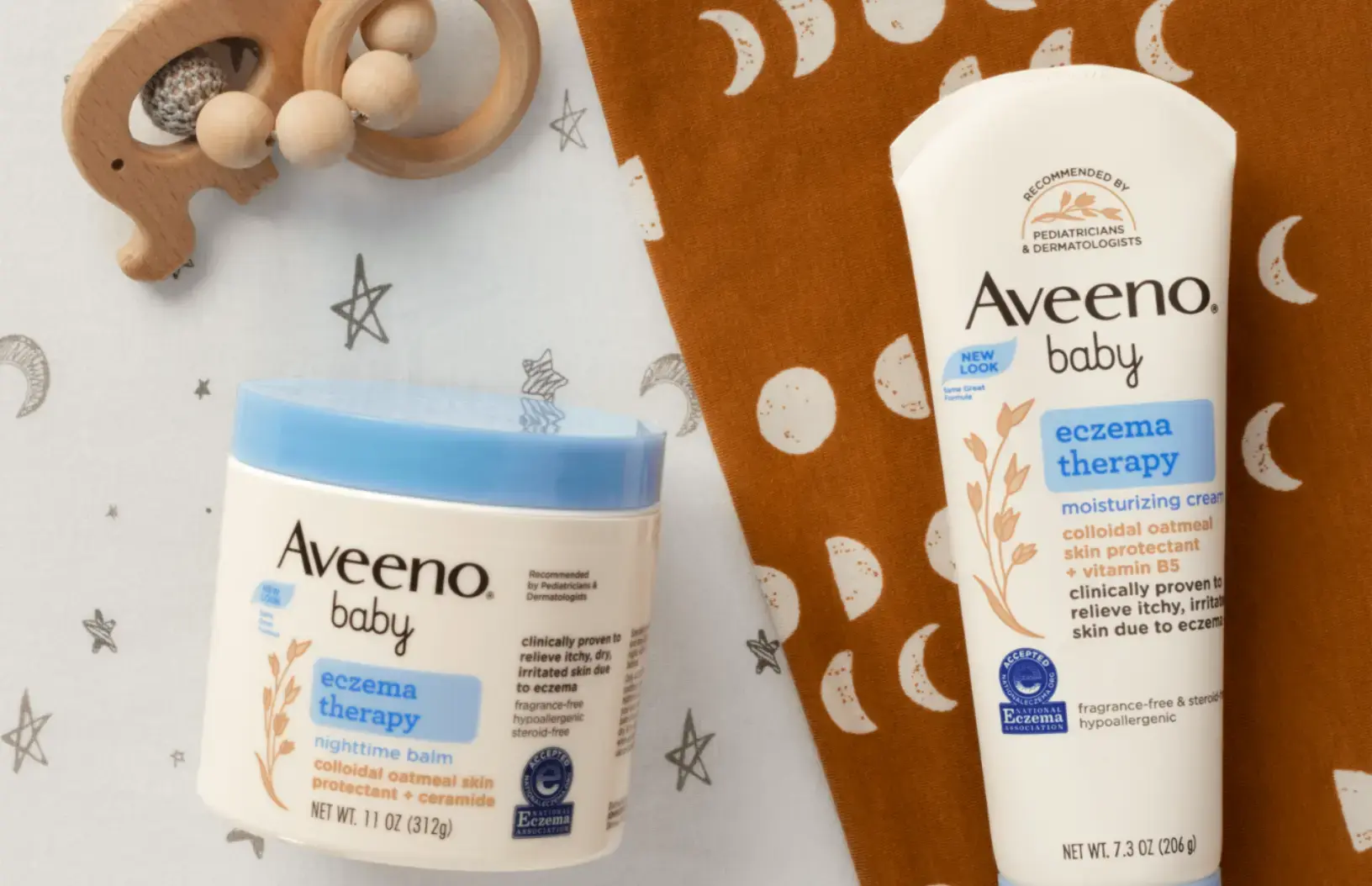 Aveeno® Baby Eczema Therapy Nighttime Cream, Eczema Therapy Moisturizing Cream and a wooden baby toy
