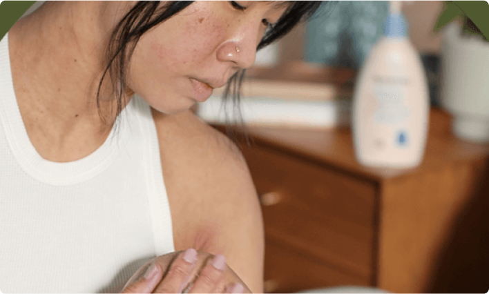 Woman looking at skin on her leg