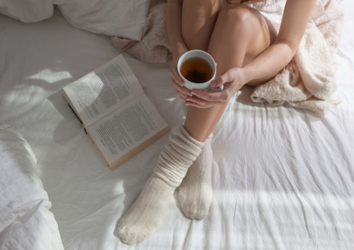 Woman wearing socks in bed