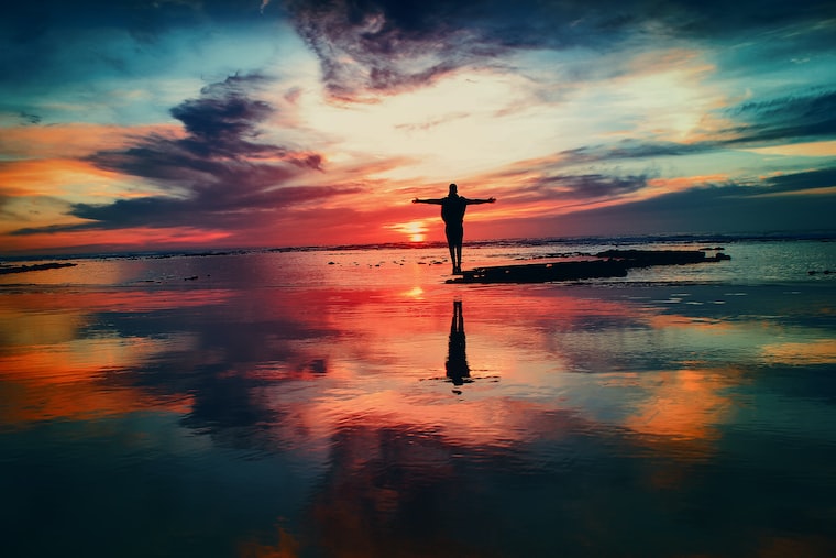 Photo of someone on a beach at sunset, by Mohamed Nohassi