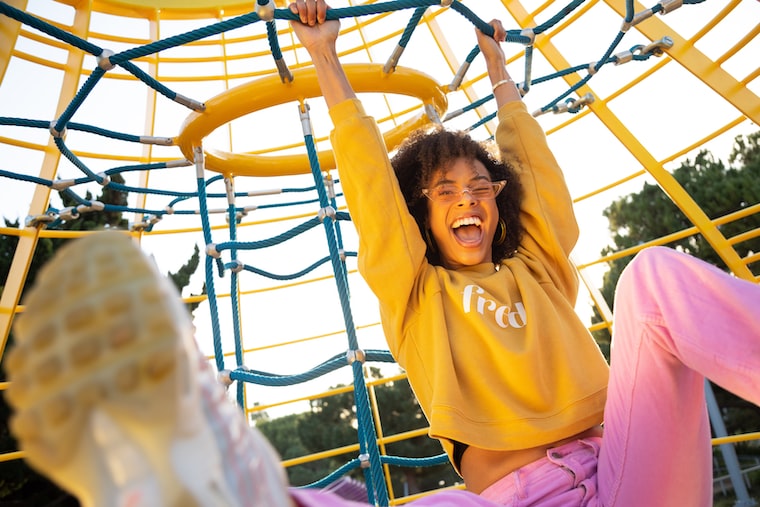 Photo of a woman having fun on a climbing frame, by Team Fredi