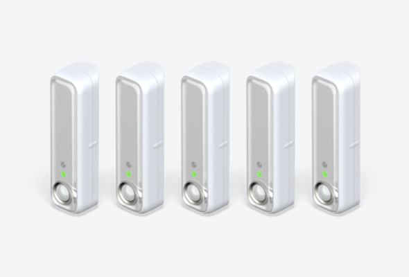 Side angle view of five Hive Motion Sensors on a light grey background