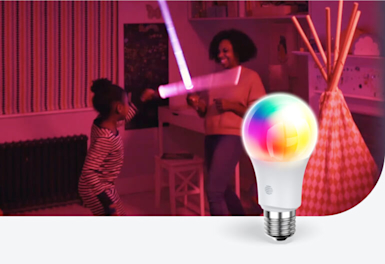 Mum and young girl playing with pink light sticks in a bedroom coloured with purple pink light, with a Hive Smart Light Bulb superimposed in the bottom right corner