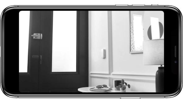Smartphone screen showing a hallway in black and white as a view from a Hive Indoor Camera