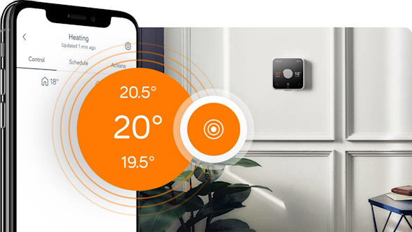 Side angle of smartphone showing the Hive app with a pop-out icon on the left of the image showing the Hive Thermostat temperature, with a Hive Thermostat attached to a white wall in the background image