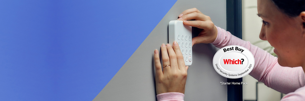 Image of a woman installing Hive Smart Home Security System Keypad on her grey wall