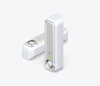 Side angle view of two Hive Motion Sensors, one standing vertical and one lying horizontal, on a white background