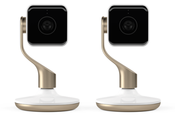 Front facing view of two Hive Indoor Cameras, in white and champagne, on a white background
