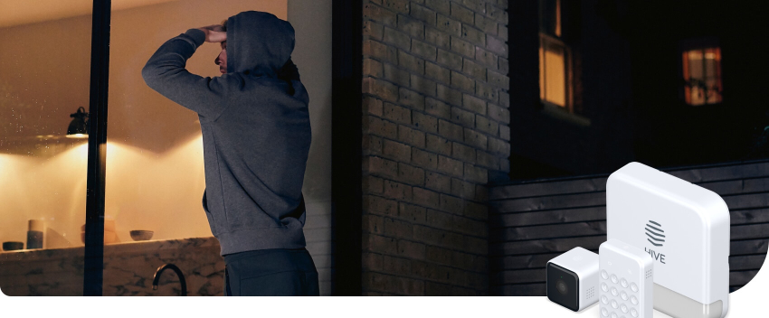An image of a man in a hoodie peering through garden glass patio doors at night with Hive smart security devices superimposed in the bottom right corner