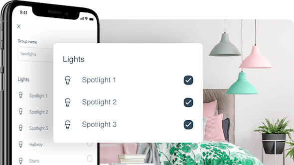 Side angle of smartphone showing Hive app with a pop-out screen in the middle of the image showing Hive bulb schedule set-up, with brightly coloured hanging lights in a bedroom in the background image