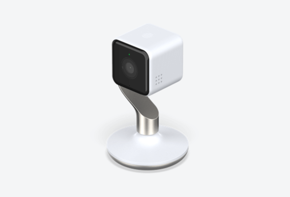 Side angle view of Hive View Indoor Camera, in white and champagne, on a light grey background