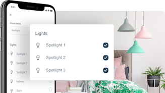 Side angle of smartphone showing Hive app with a pop-out screen in the middle of the image showing Hive bulb schedule set-up, with brightly coloured hanging lights in a bedroom in the background image