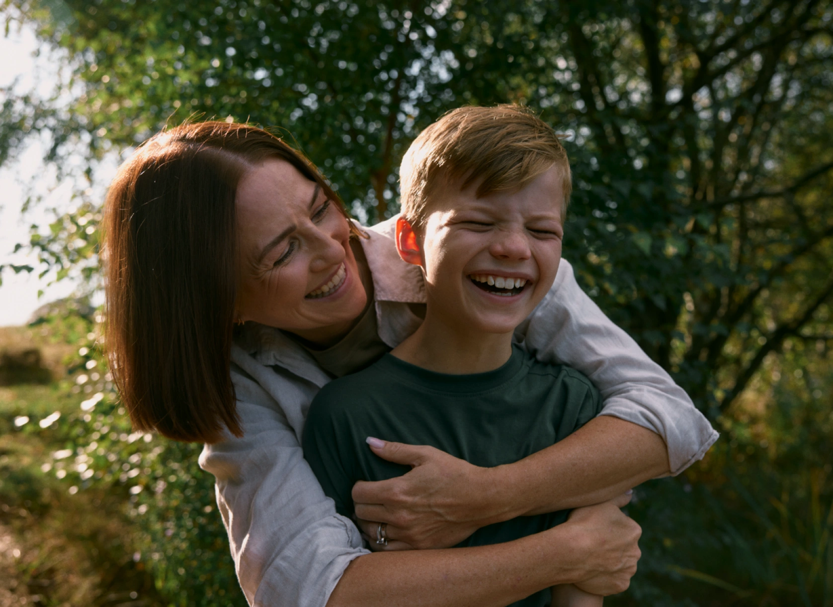A mum and her son smiling