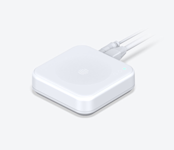 Side angle view of Hive Hub, with cables attached to the back, on a white background