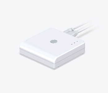 Side angle view of Hive Hub, with cables attached to the back, on a white background