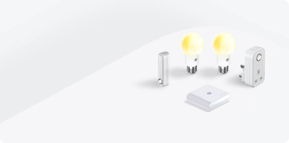 Composite image of Hive smart devices, including Hive smart light bulbs, Hive Plug, Hive Motion Sensors and a Hive Hub, on a light grey background