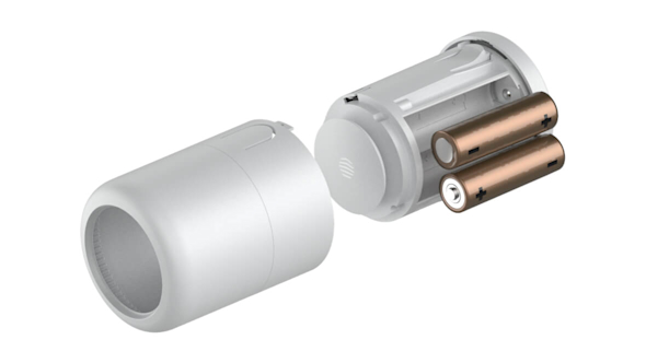 Hive Radiator Valve in two pieces with 2 x AA batteries being added to the inner piece, on a white background