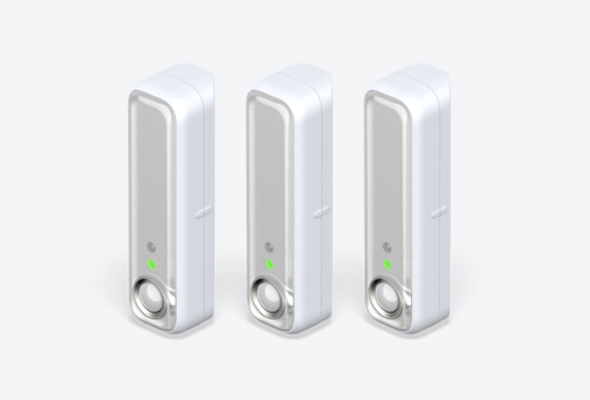 Side angle view of three Hive Motion Sensors on a light grey background