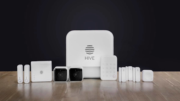 Range of Hive smart devices sitting on a wooden floor with a dark blue wall in the background