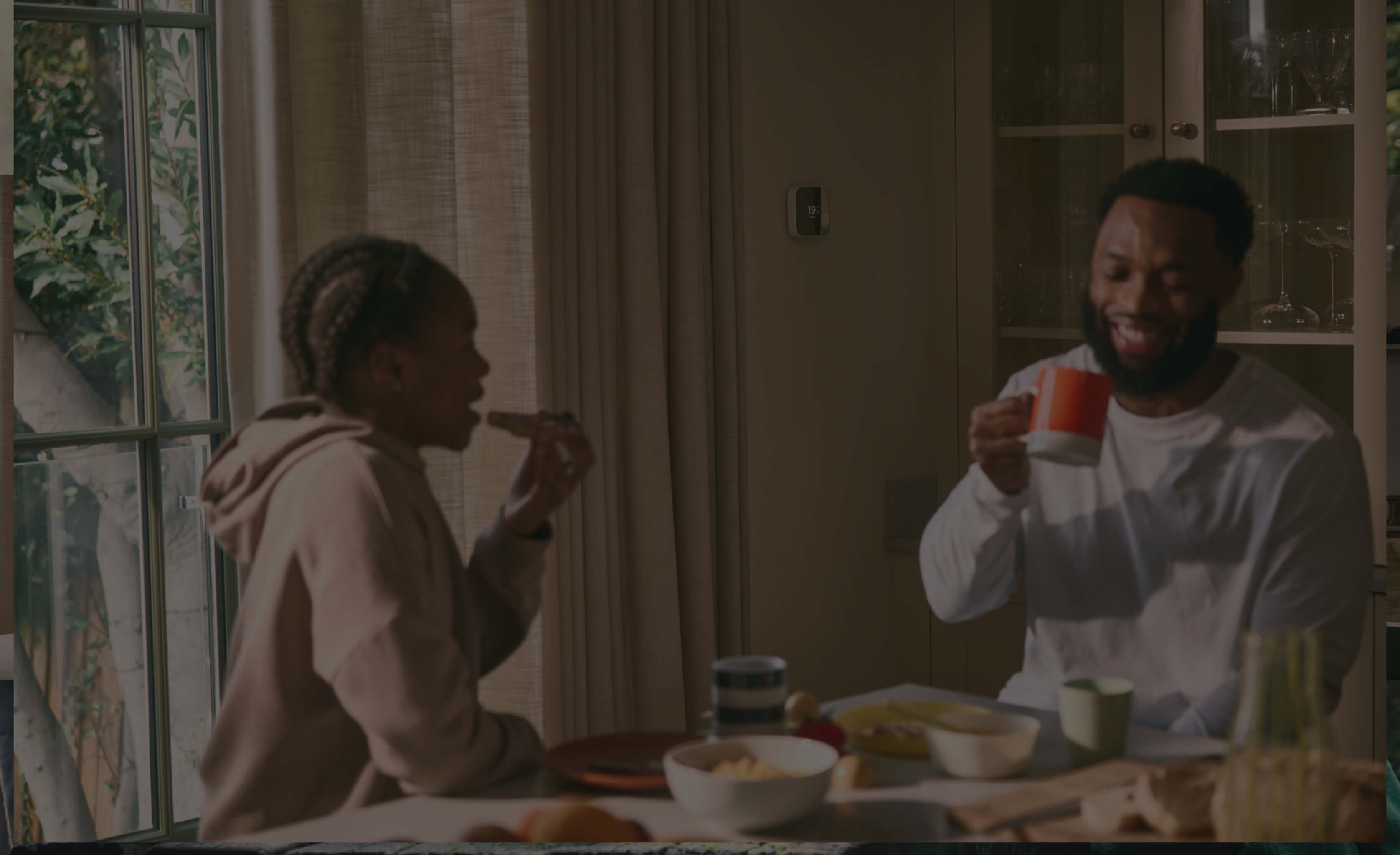 Hive Thermostat in the kitchen with a father and child laughing