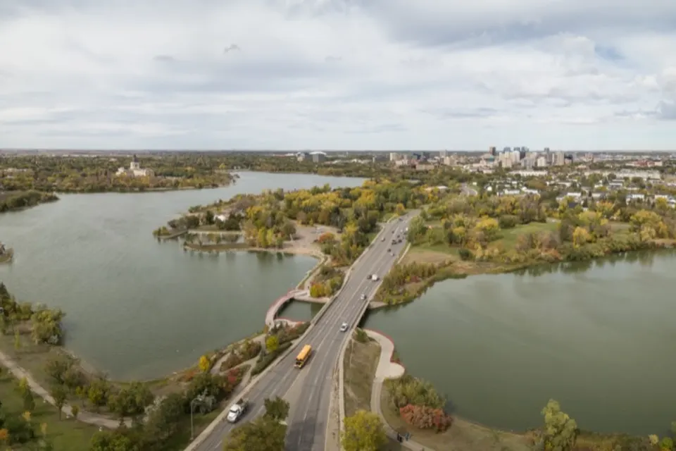 Aerial view of Regina with roads, lakes, and surrounding greenery.