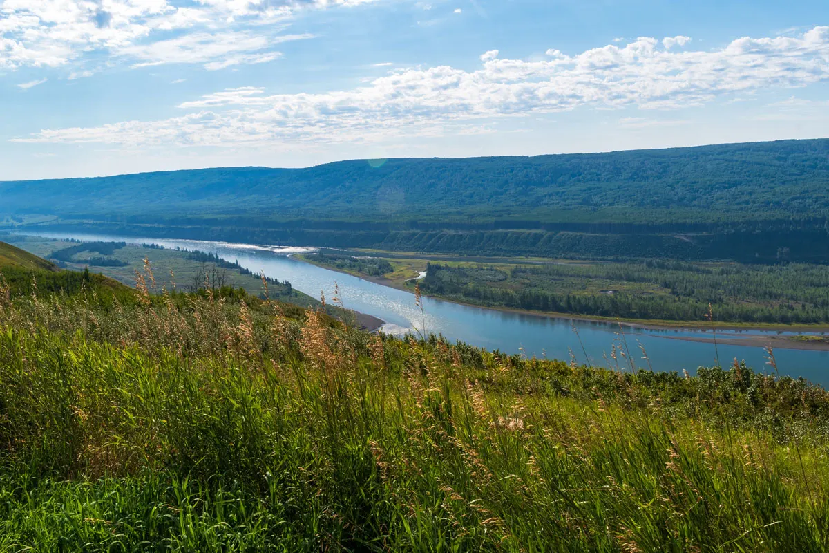 Scenic view of a river winding through hills and grasslands near Fort Saint John.