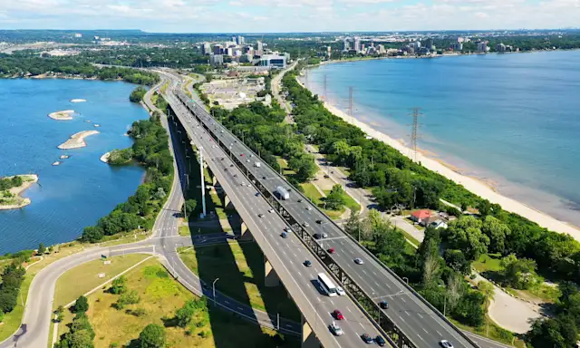Aerial view of the Burlington Skyway bridge and surrounding area, with Lake Ontario and Burlington's waterfront.