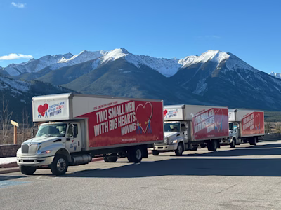 3 Two Small Men with Big Hearts Moving Vans in a row as they travel through the mountains.