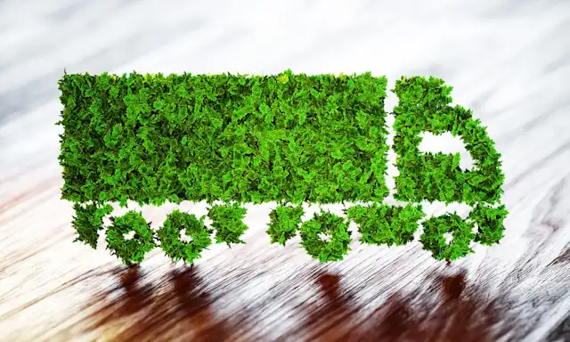 Truck silhouette made of green foliage, symbolizing eco-friendly transportation.