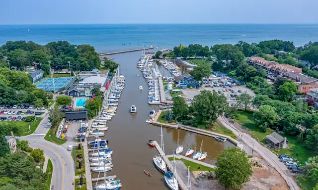 Aerial view of a marina near Oakville, with boats docked along a river leading to a lake.