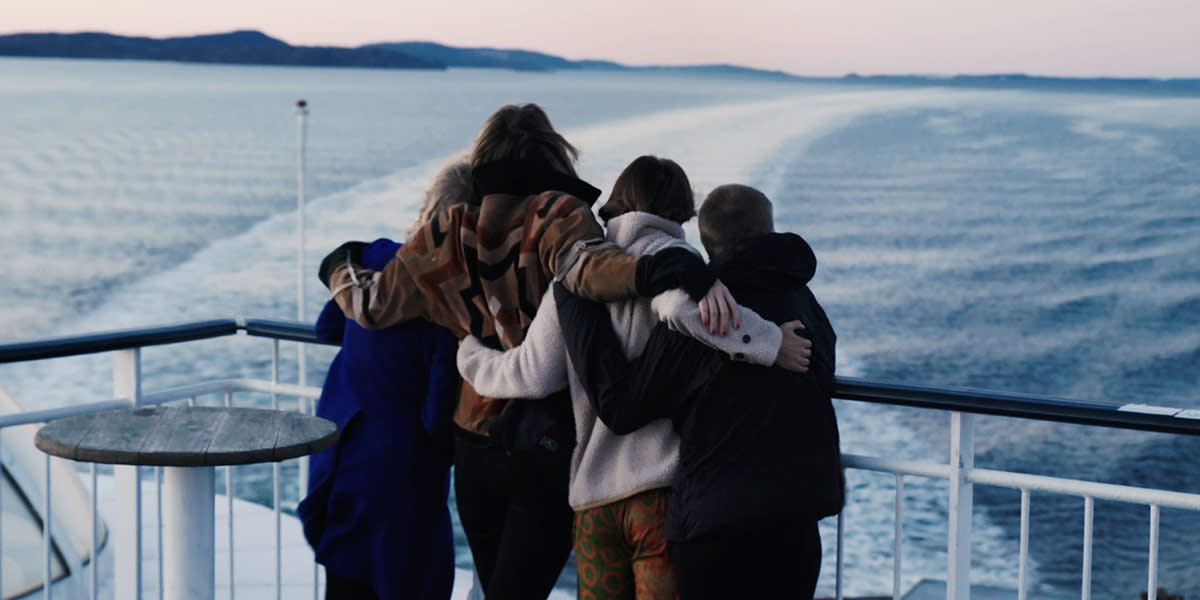 Family on deck hugging Promo