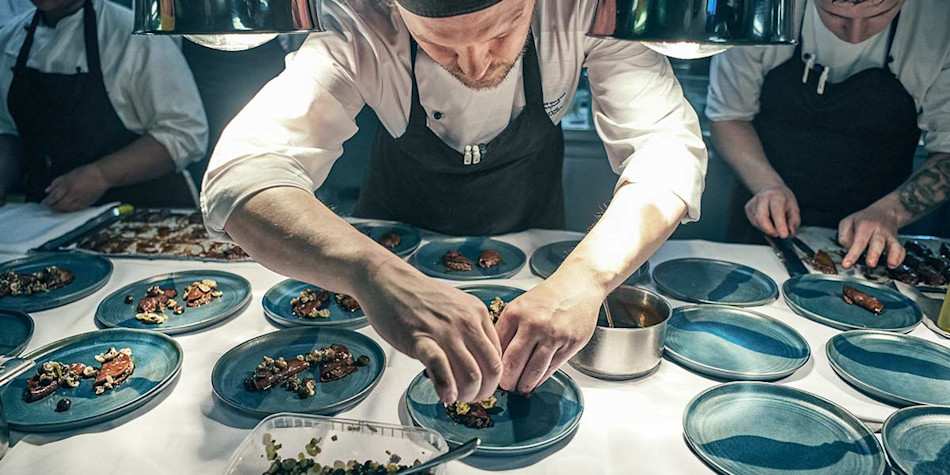 Chefs preparing food for Sjo onboard restaurant