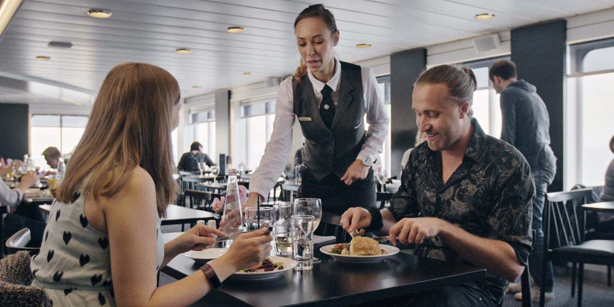 Couple dining in Explorers Kitchen onboard Newcastle-Amsterdam