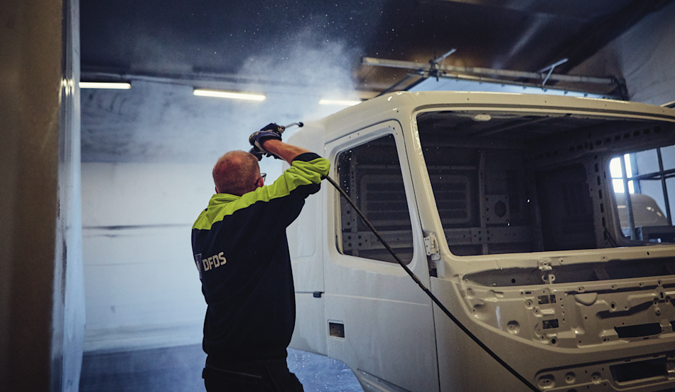 A DFDS employee washing a truck at the Gothenburg terminal
