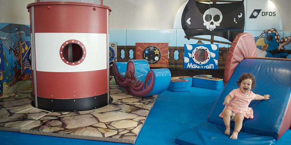 Small child having fun sliding down in Pirates Island onboard Eastern Channel Ferry.