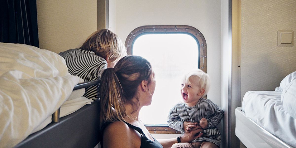 A family laughing with each other in a seaview cabin