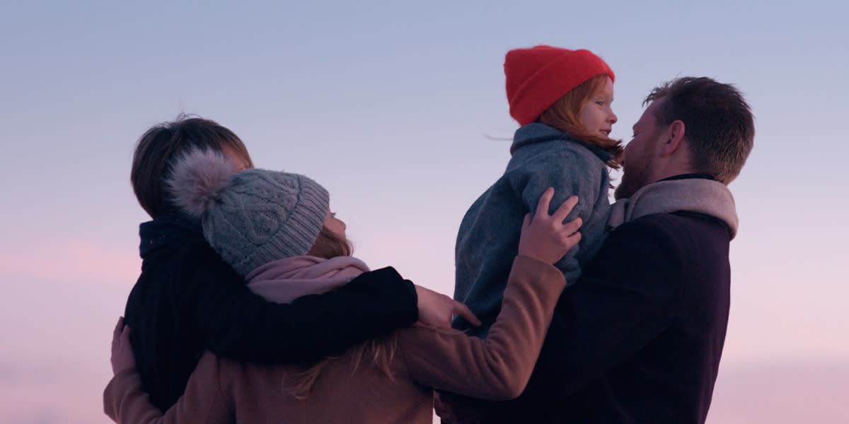 Family with kids watching sunset