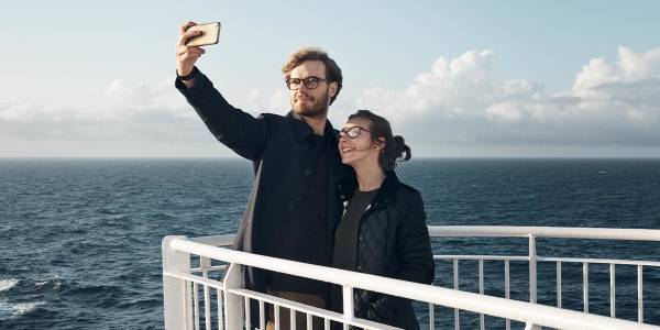 Couple taking selfie on deck Promo