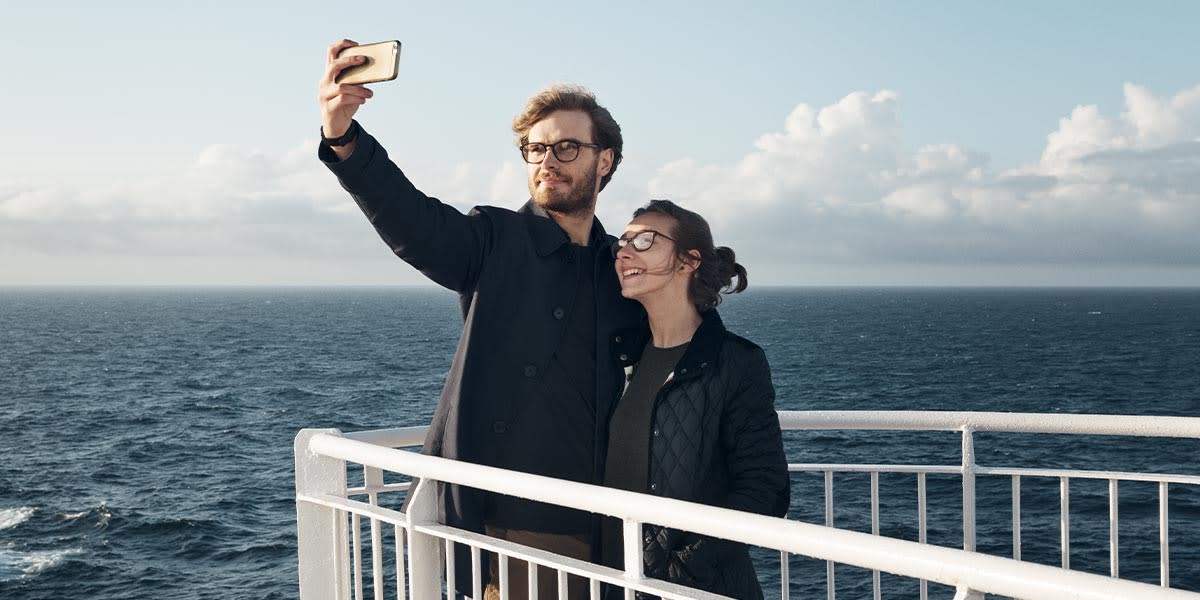 Couple taking selfie on deck Promo Couple taking selfie on deck Promo