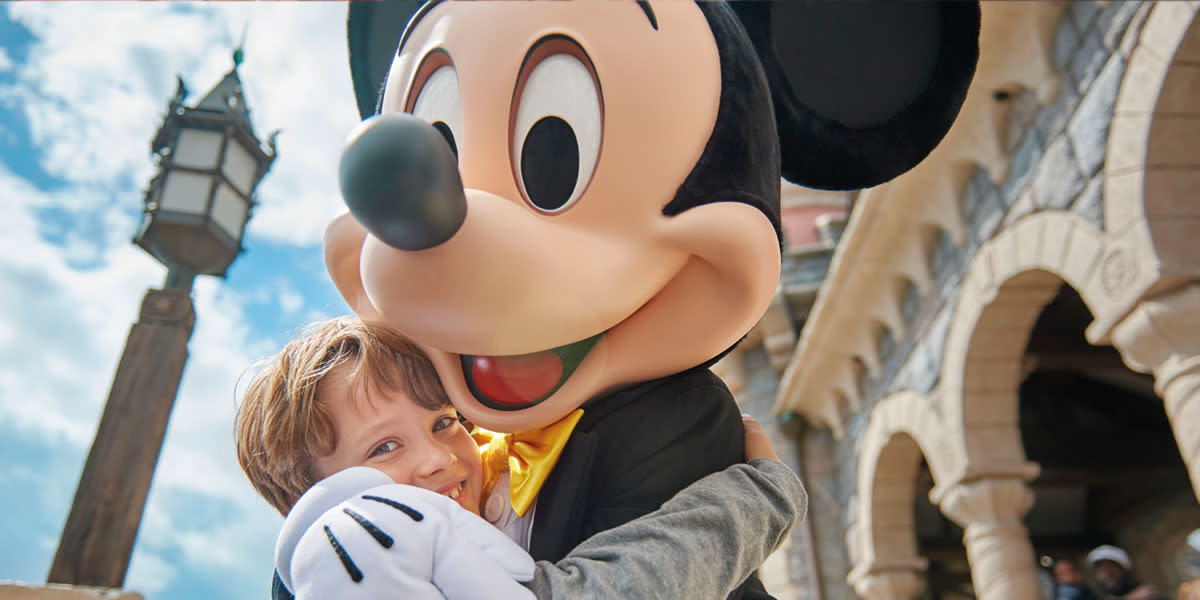 Boy at Disneyland® Paris with Mickey Mouse