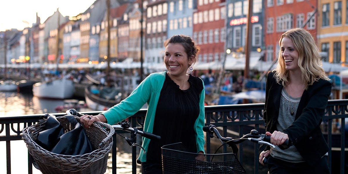 To damer med sykkel på en bro i Nyhavn