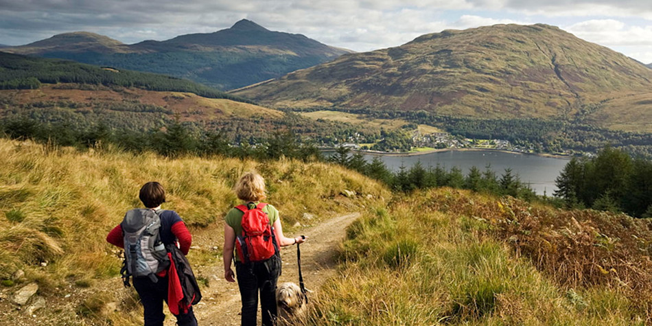Friends discovering lake mountains Scotland 