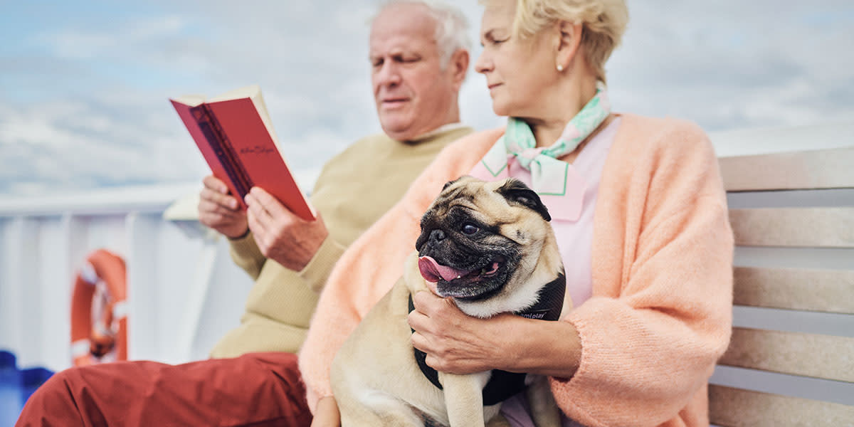 Couple on deck with a dog