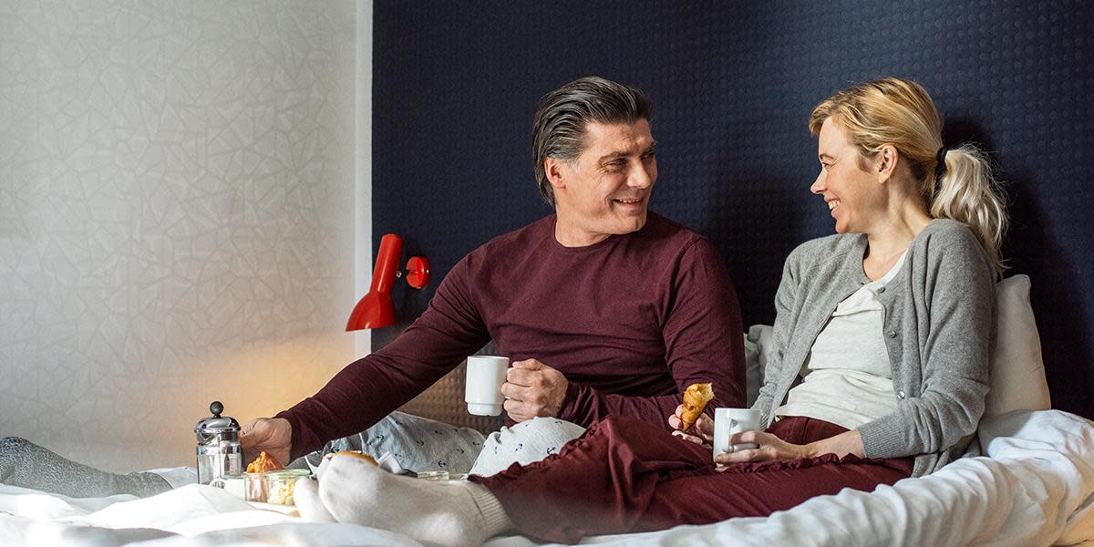 Couple having breakfast in bed exp 01_04_2029